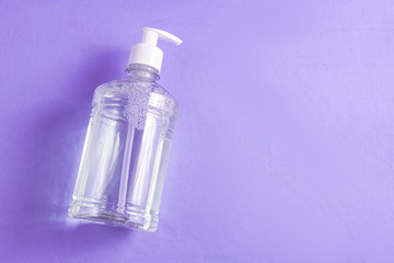 Container with alcohol gel on the light blue background