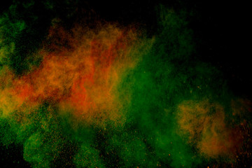 Colorful powder explosion on black background. Colorful dust explode. Paint Holi.