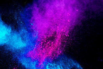 Colorful powder explosion on black background. Colorful dust explode. Paint Holi.
