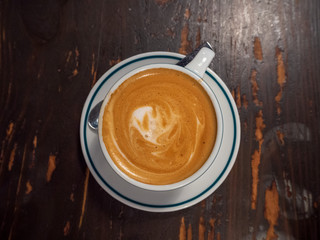 Close up image of coffee cafe latte with spoon at the cafe from the top