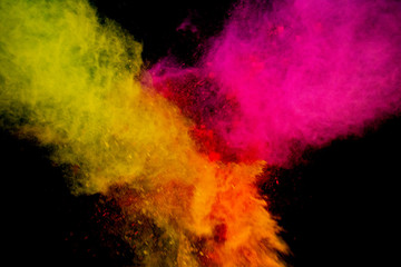 Colorful powder explosion on black background. Colorful dust explode. Paint Holi.