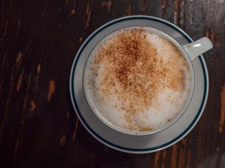 A cup of cappuccino isolated from top view with copy space