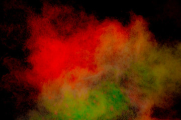 Colorful powder explosion on black background. Colorful dust explode. Paint Holi.