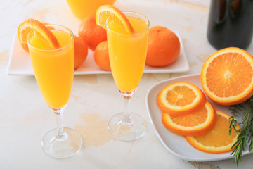 Glasses of tasty mimosa cocktails on table