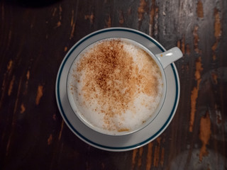 A cup of cappuccino isolated from top view with copy space