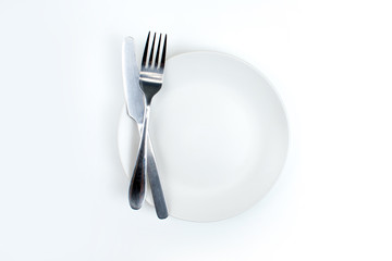 A spoon and fork on a white plate