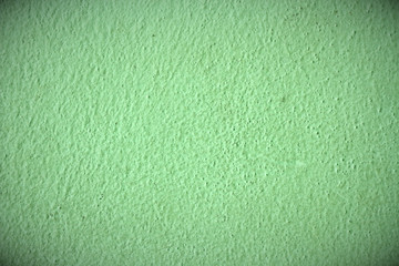 vignette background cement wall painted light green colour.