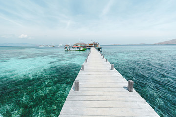 Wooden bridge over the sea. Travel and Vacation. Wooden bridge on the tropical beach and blue sky...