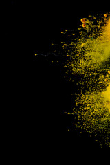 Colorful powder explosion on black background. Colorful dust explode. Paint Holi.