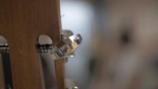 Close Up of String Cuatro instrument,, artist playing folk music, musical instrument string, slow motion / toma cercana de un instrumento de cuerdas, el cuatro, artista tocando instrumento folclorico.