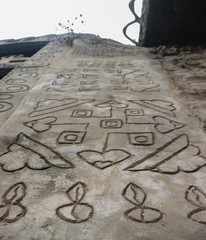 Different types of art and drawing made on the wall. the front part is in focus and the background is blurred