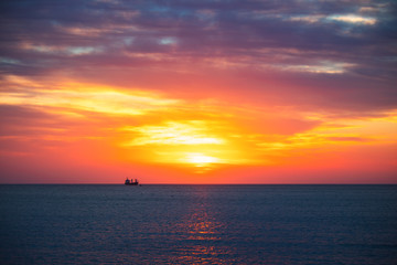 Fototapeta na wymiar Cargo ship with containers in sunrise light