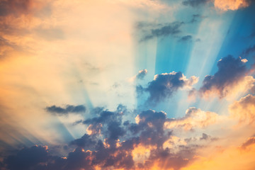 Sunset dramatic sky clouds with sunbeam