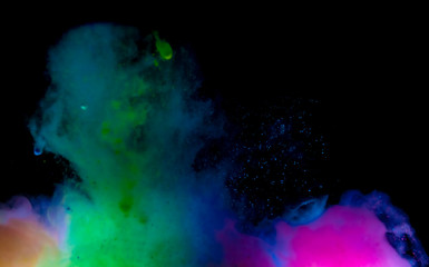 Fototapeta na wymiar Abstract art powder paint on black background. Movement abstract frozen dust explosion multicolored on black background.