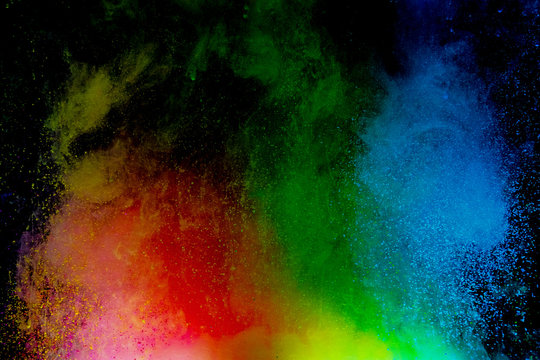 Abstract art powder paint on black background. Movement abstract frozen dust explosion multicolored on black background. © Nat PhotO