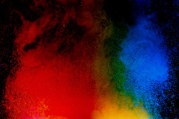 Fototapeta premium Abstract art powder paint on black background. Movement abstract frozen dust explosion multicolored on black background.