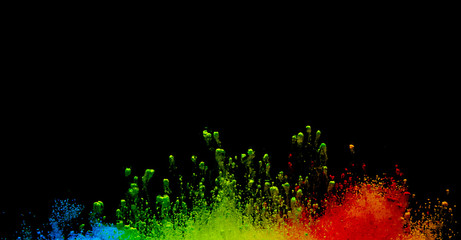 Abstract art powder paint on black background. Movement abstract frozen dust explosion multicolored on black background.