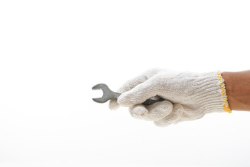 Hand with glove holding spanner with copy space. 