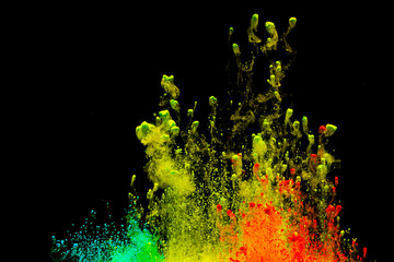 Abstract art powder paint on black background. Movement abstract frozen dust explosion multicolored...