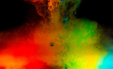 Abstract art powder paint on black background. Movement abstract frozen dust explosion multicolored on black background.