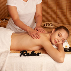 Obraz na płótnie Canvas Beautiful young woman having a massage treatment in spa salon - wellness
