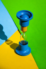 Hourglass colored background, copy space for text, Hourglass shows that time is running out