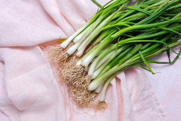 Fresh red and white onions on pink background