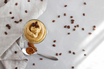 Top view of a trendy dalgon cold drink in milk with brown instant coffee foam. Copy space