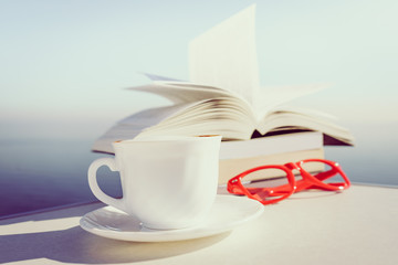 Coffee cup and books outdoors