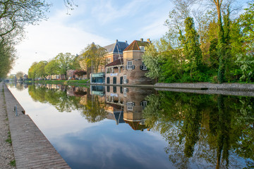 Canal view of a beautiful historical building/architecture in Delft.