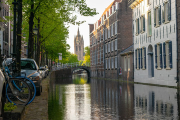A view from a dutch canal with typical dutch houses and bridges. 