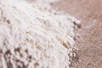 Heap of dry flour on textile. Cooking flour products concept.