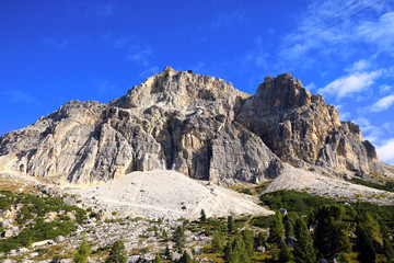 Beautiful Dolomites in Italy. Clear day with blue sky. Mountains are illuminated by the rays of the sun. Clean fresh air. Selective focus.