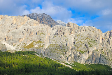 Beautiful Dolomites in Italy. Clear day with blue sky. Mountains are illuminated by the rays of the sun. Clean fresh air. Selective focus.