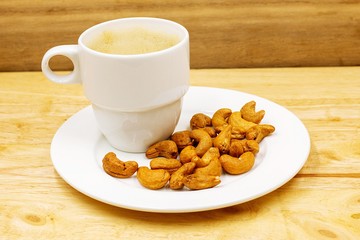 The cashew tree is a tropical evergreen tree that produces the cashew seed and the cashew apple. The tree can grow as high as 14 m, but the dwarf cashew, growing up to 6 m, has proved more profitable,