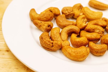 The cashew tree is a tropical evergreen tree that produces the cashew seed and the cashew apple. The tree can grow as high as 14 m, but the dwarf cashew, growing up to 6 m, has proved more profitable,