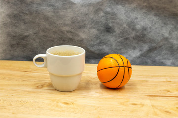 Basketball break time with a cup of coffee tea hot drink on wooden floor