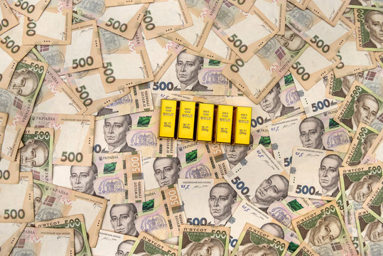 stacks of gold bars on ukraine moneu uah . top view