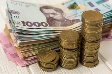 diagram of coin  money growth effect with lot of ukraine money banknotes. For business growth and financial concept