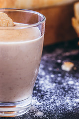Homemade cookie cream in a glass on a dark background.