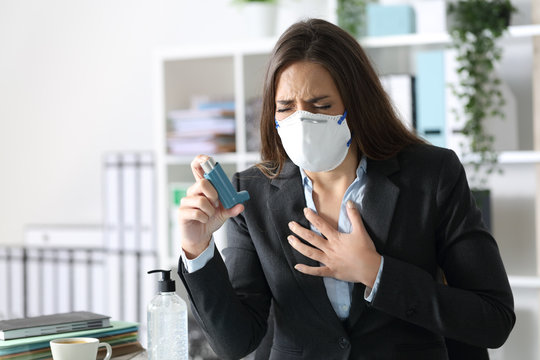 Executive wearing mask with asthma holding inhaler