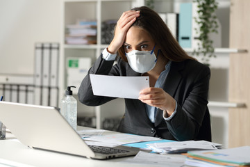Surprised executive with mask looking at receipt at office