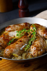 Homemade white sausage fried with onion and herbs