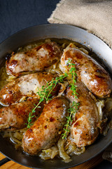 Homemade white sausage fried with onion and herbs