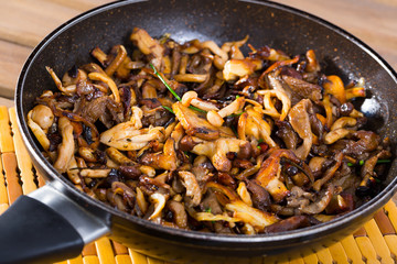 Delicious freshly cooked fried shitake mushrooms in a frying pan