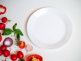 Cook frame with fresh vegetables and plate on white background top view