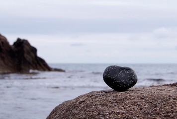 heart shaped stone on the sea beach