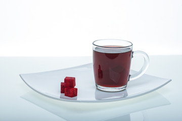 beets and beetroot juice on a glass table on a white background