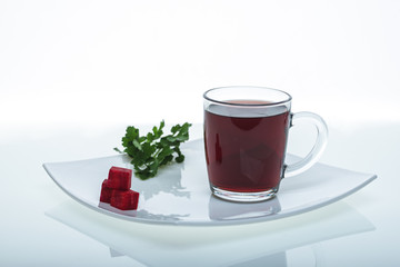 raw beets and beetroot juice in glass and parsley on plate isolated on white background, close view root