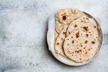 Homemade indian flatbread chapati on a gray background. Vegetarian cuisine concept.